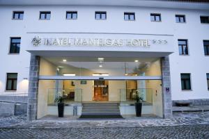 a building with a sign for a hotel at INATEL Manteigas in Manteigas