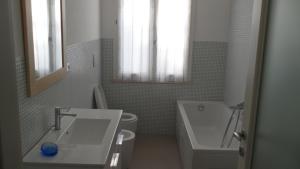a bathroom with a sink and a tub and a toilet at CASA FLAMINIA in Pesaro
