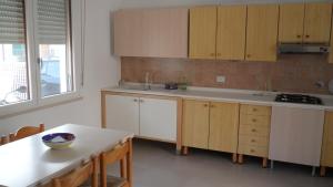 a kitchen with wooden cabinets and a white counter top at CASA FLAMINIA in Pesaro