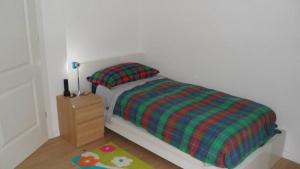 a small bedroom with a bed and a night stand at CASA FLAMINIA in Pesaro