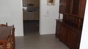 a living room with a wooden cabinet and a kitchen at CASA FLAMINIA in Pesaro +10 photos
