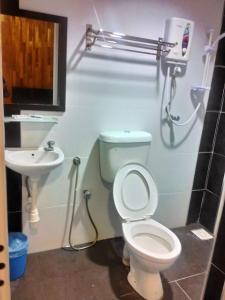 a bathroom with a toilet and a sink at Mabohai Resort Klebang in Malacca