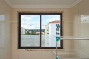 a window with a view of a city at BeGuest Cascais Inn Apartments in Cascais
