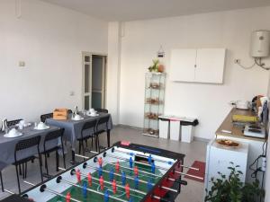 a room with tables and chairs and a table with flags on it at Sunset B&B Pompei in Pompei