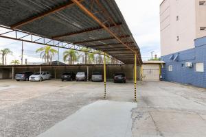 a parking lot with cars parked in a garage at Hotel Expressinho Aeroporto in Porto Alegre