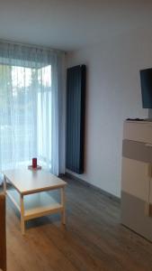 a living room with a coffee table in front of a window at Studio COTE BRUNE 2 ALPES in Les Deux Alpes