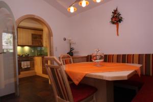 a kitchen and dining room with a table and chairs at Chalet Walzl in Längenfeld