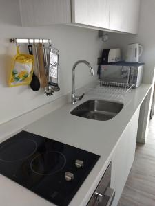 a kitchen with a sink and a counter top at Departamentos de Lujo ,costado Mall Plaza in Antofagasta