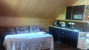 a room with a bed and a sink in a room at Котедж "Хата Рибака" in Kosiv