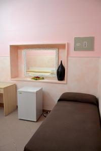 A bed or beds in a room at Ostello Salento