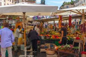 a group of people at a market with fruits and vegetables at LikeHome Milano - Via Crema in Milan