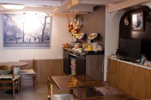 a dining room with a table and a tv at Hostel The Veteran in Amsterdam