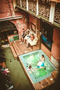 a group of people sitting in a swimming pool at The Clock Hostel & Suites in Cartagena de Indias