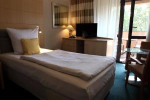 a hotel room with a bed and a television at Hotel Katrina in Ostrzeszów