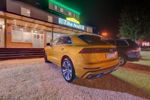 a yellow car parked in front of a restaurant at Tihe Noci in Pale