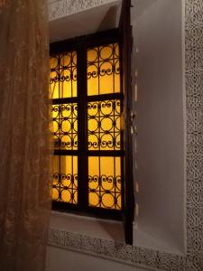 a door with a window with a lattice pattern at Riad Anass Al Ouali in Fez