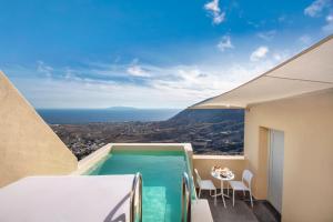 a view of a swimming pool from a hotel room at Skyfall Suites - Adults Only in Pyrgos