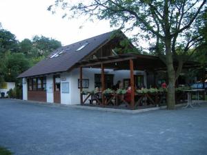 a building with a table with flowers in front of it at Camping Matyáš in Vrané nad Vltavou
