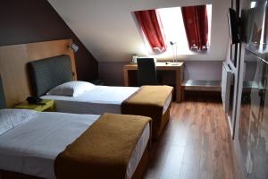 En eller flere senger på et rom på Hotel Eurocap