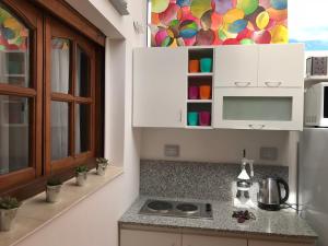 a kitchen with white cabinets and a counter top at Casamia Altos in Bahía Blanca +57 photos