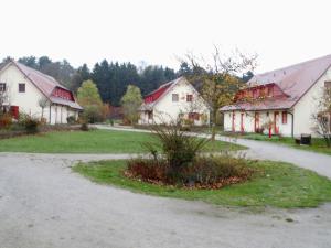 a group of white buildings with red roofs at Wowi Ferienwohnung B 53 in Dranske