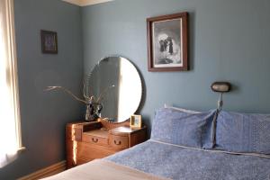 a bedroom with a bed and a mirror at Chester St Backpackers in Christchurch