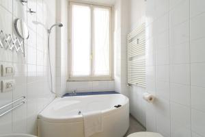 A bathroom at White Napoleone Apartment