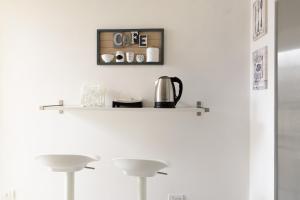 Coffee and tea making facilities at White Napoleone Apartment