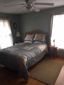 a bedroom with a bed and a ceiling fan at Four Creeks Bed&Breakfast in Fairview