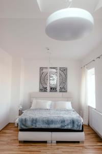 a bedroom with a large bed with a blue blanket at Luxury Apartments Zelny Trh in Brno
