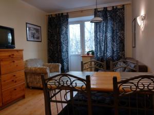 a living room with a dining room table and chairs at Three Bedroom Stepana Bandery Street in Rivne