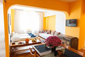 a living room with yellow walls and a couch at Vitosha Blvd - Family and Friends Apart in Sofia