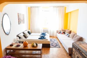 a living room with two beds and a couch at Vitosha Blvd - Family and Friends Apart in Sofia