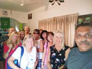 a group of people are posing for a picture at Green Leaf Home Stay in Thekkady