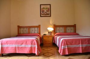 Łóżko lub łóżka w pokoju w obiekcie Hotel Posada Escudero