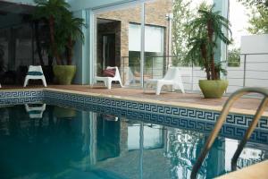 a house with a swimming pool and chairs next to a house at Casa de Campo Memórias da Comarca in Arganil