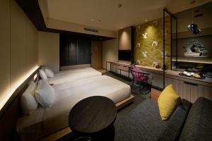 a bedroom with a bed and a table and a couch at Shibuya Granbell Hotel in Tokyo