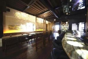 a restaurant with tables and chairs in a room at Shanghai Soho Garden Hotel in Shanghai