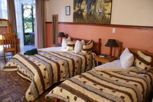 a hotel room with two beds in a room at Airport Inn Bed and Breakfast in Kempton Park