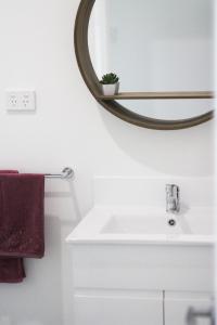 a bathroom with a sink and a mirror at Island Cottages in Nelly Bay