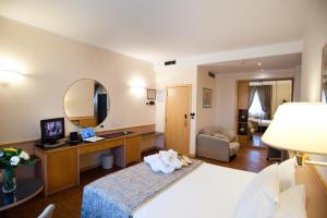 Postel nebo postele na pokoji v ubytování Hotel Minerva