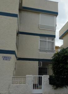 a building with blue stripes on the side of it at Jazmines in Santiago de la Ribera