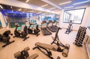 a gym with a bunch of exercise bikes in it at Charming 3-Bedroom Apartment in Poiana Brasov