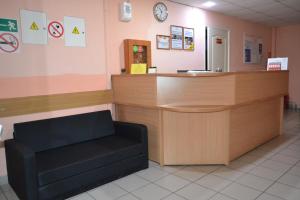 a waiting room with a counter and a chair at Hotel Rassvet in Saransk