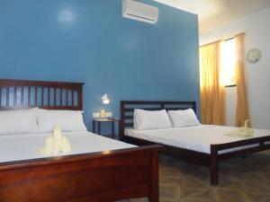 Postel nebo postele na pokoji v ubytování Mayas Guesthouse