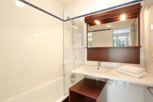 a bathroom with a sink and a shower and a mirror at Vacancéole - Le Domaine de Chames - Pont d'Arc in Vallon-Pont-dʼArc