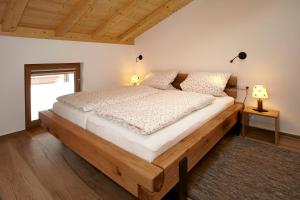 a bedroom with a large wooden bed in a room at Herz im Winkl in Reit im Winkl