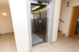 a elevator in a building with a glass door at Luxury Apartments Bolf in Pohorje