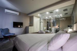 a bedroom with a large bed and a bathroom at The Leverage Business hotel (Skudai) in Johor Bahru