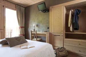 Postel nebo postele na pokoji v ubytování Hotel Funivia